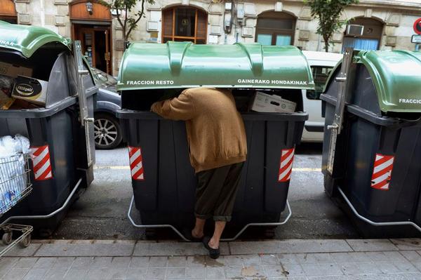 bask woman sorting garbage
